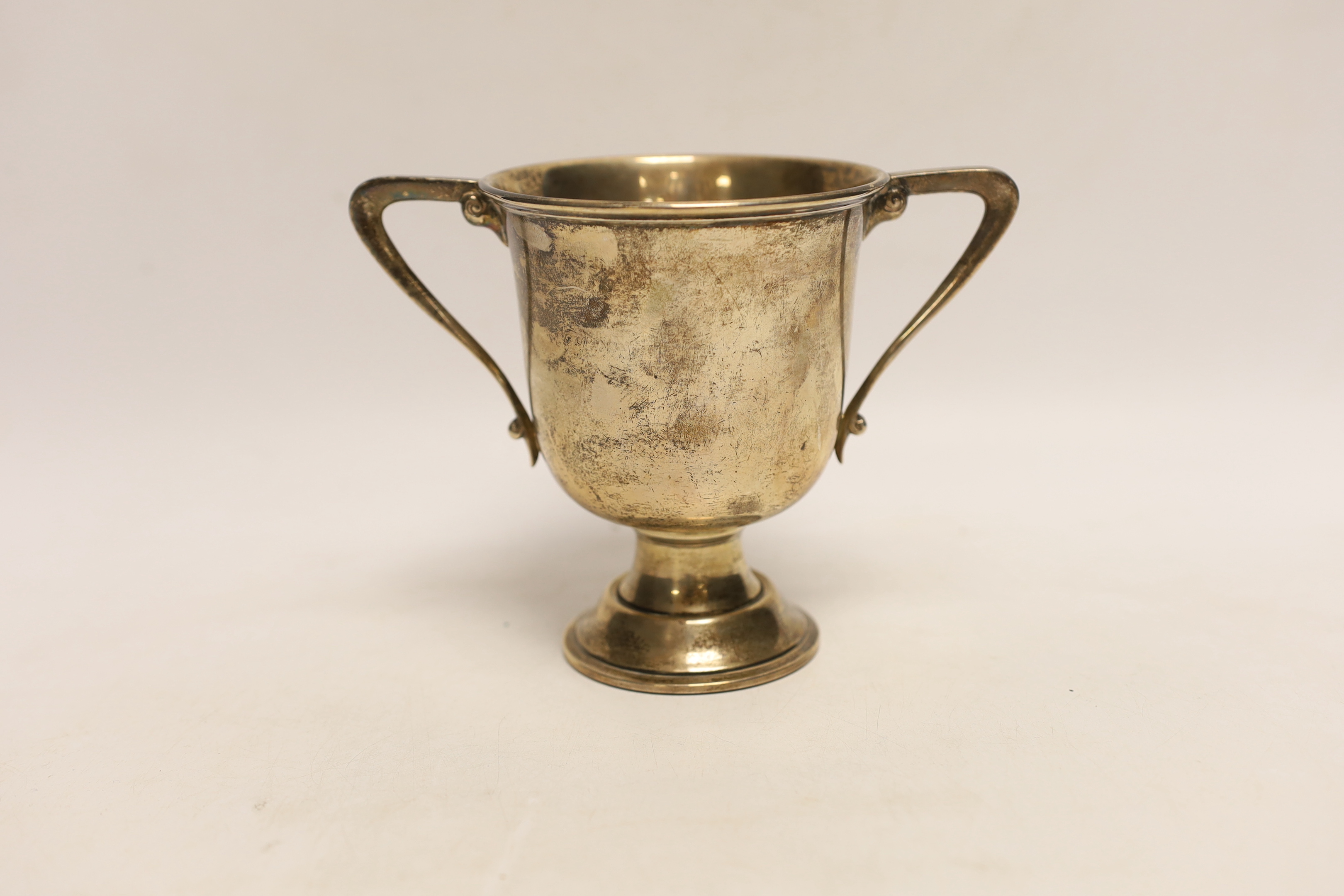 A George V silver two handled trophy cup, Charles Edwards, London, 1921, 12.2cm, 8.4oz.